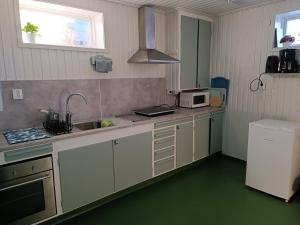 a kitchen with a sink and a microwave at Large apartment with sauna in central Mora in Mora