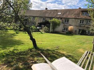 an open book in front of an old house at Moulin de Vilgris in Clairefontaine