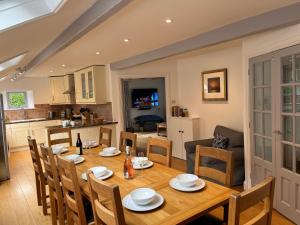a dining room and kitchen with a table and chairs at Spring Barn at Bolberry Court in Hope-Cove