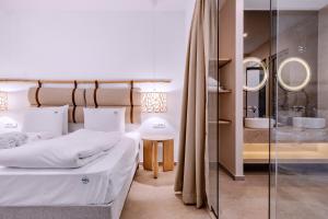 a bedroom with two beds and a glass wall at Vila Bisera in Ohrid