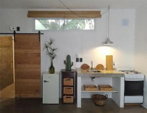 a kitchen with a counter and a sink in a room at Aloja Merlo - Conectá con la naturaleza in Merlo