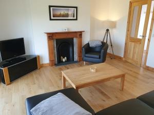 a living room with a couch and a fireplace at Bayview 1-Bed Cottage in Isle of Lewis in Bragor