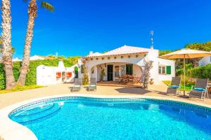 a villa with a swimming pool and a house at Villa Miguel Dos in Cala'n Bosch