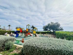 a playground with a slide in a park at A1040 - Terramar 1 - 2004 Finestrat in Villajoyosa