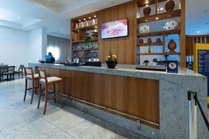 eine Bar in einem Restaurant mit Hockern in der Unterkunft Beach Class #1104 - Quádruplo por Carpediem in Recife