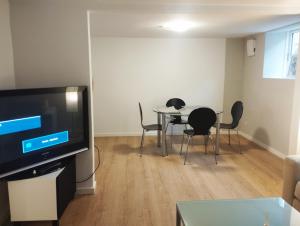 a living room with a table and chairs and a television at (id115) Nørregade 51 kl in Esbjerg