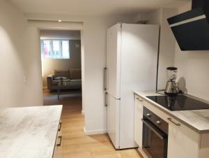a kitchen with a refrigerator and a living room at (id115) Nørregade 51 kl in Esbjerg