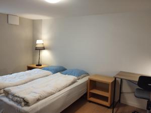 a bedroom with two beds and a desk with a lamp at (id115) Nørregade 51 kl in Esbjerg