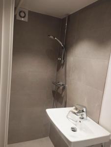 a bathroom with a sink and a shower at (id115) Nørregade 51 kl in Esbjerg