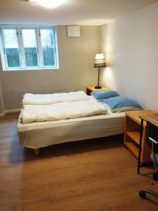 a bedroom with a large bed with a lamp on it at (id115) Nørregade 51 kl in Esbjerg