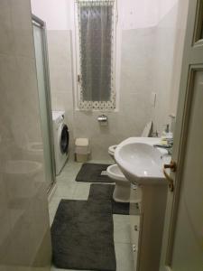a white bathroom with a sink and a toilet at Verde Monte Di Portofino by PortofinoVacanze in Rapallo