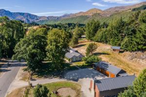 an aerial view of a house in a valley with mountains at Stone Cottage in Arrowtown