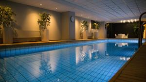 a large swimming pool in a hotel room at Original Sokos Hotel Lappee in Lappeenranta