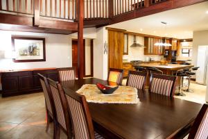 a kitchen and dining room with a wooden table and chairs at Sondela Nature Reserve & Spa Makhato Lodges in Bela-Bela