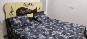 GhāzīpurにあるMaa durga guest houseのベッド(白黒の掛け布団付)
