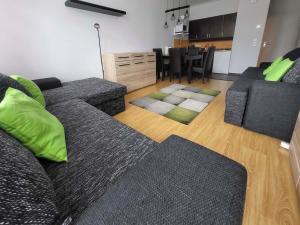 a living room with a couch and a dining room at Grimming view Apartment in Tauplitz