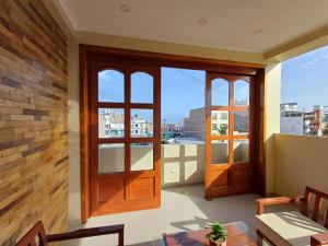 a room with two doors and a view of a city at Arena Hostal in Paracas