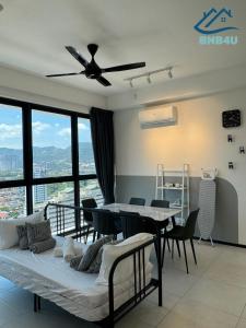 a room with a bed and a table and chairs at Urban Suites @ George Town Penang by BNB4U in George Town