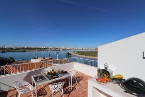 a balcony with a view of the water at Casa Herzog in Ferragudo