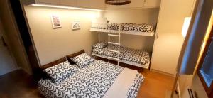 a room with two bunk beds and a couch at El Refugio de Enveitg in Enveitg +27 photos