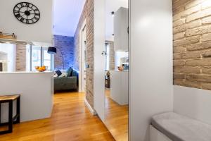 a room with white walls and a brick wall at Apartament Na Deptaku in Lublin