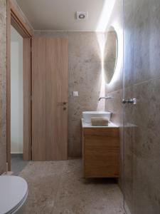 ein Badezimmer mit einem Waschbecken, einem WC und einem Spiegel in der Unterkunft Casa Del Centro Storico,By IdealStay Experience in Iraklio