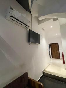 a room with a couch and a tv on the wall at Hotel Jk Residency- 4 min walk from Golden Temple in Amritsar