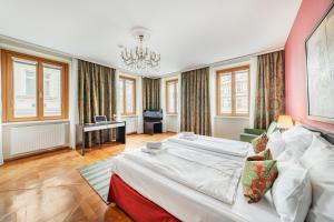 a bedroom with a large bed and a chandelier at Serviced-Appartements-Josefstadt in Vienna