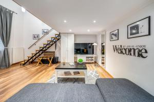 a living room with a couch and a staircase at Sweet Dreams at Oktogon in Budapest