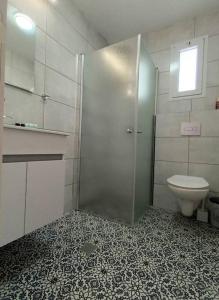 a bathroom with a shower and a toilet at Sraya Hostel_Big in Majdal Shams