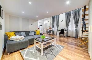 a living room with a couch and a table at Sweet Dreams at Oktogon in Budapest