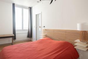 a bedroom with a red bed and a window at Modern apartment in Paris in Paris