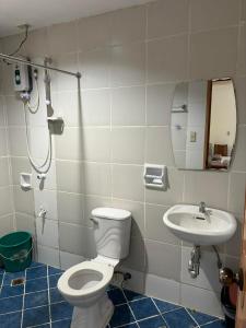 a bathroom with a toilet and a sink at VILLA LOURDES RESORT in Boracay