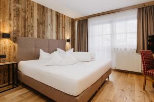 Postel nebo postele na pokoji v ubytování Hotel Dorfer