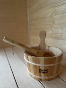 a wooden bowl with a spoon in it on a table at Czaple Resort in Stare Czaple