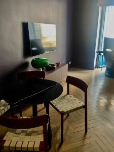 uma sala de estar com uma mesa e cadeiras e uma tigela verde em Apartment close to the beach - 3 min walk em Nice
