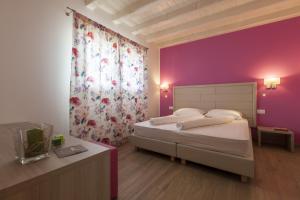 Postel nebo postele na pokoji v ubytování Agriturismo Ai Casoni