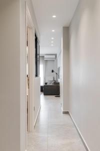 a hallway with white walls and a living room at #Nereids Apts by halu! Apartments in Thessaloniki