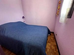 - une chambre avec un lit bleu dans l'établissement Bret, à Valras-Plage