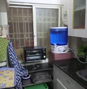 a kitchen with a counter top with a food processor at Casa di Mara in Puttaparthi