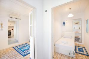 a small room with a small bed and a hallway at Kokkari's Destiny - at the heart of the City Center in Kokkari +8 photos