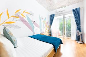 a bedroom with a bed with a mural on the wall at Cat Ba Countryside Homestay in Cat Ba