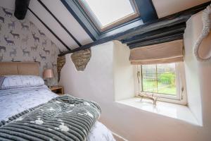a bedroom with a bed and a window at Cosy cottage in rural Ludlow, Seifton View Cottage Culmington in Culmington