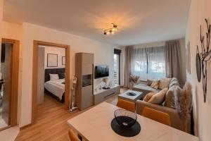 a living room with a couch and a bed at Apartment Forma in Zlatibor