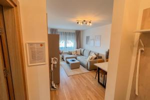 a living room with a couch and a table at Apartment Forma in Zlatibor