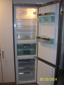 an empty refrigerator with its door open in a kitchen at Villa Rogge in Berlin