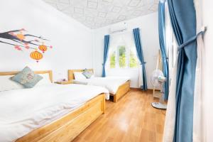 a bedroom with two beds and a window at Cat Ba Countryside Homestay in Cat Ba