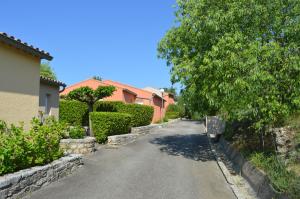 an empty street in a residential neighborhood with houses at le moulin in Vallon-Pont-dʼArc