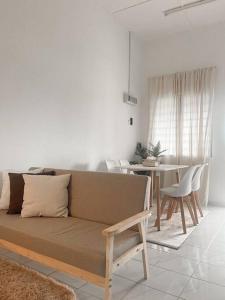 a living room with a couch and a table at The White Sands Homestay Pekan Pahang in Pekan