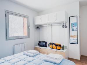 a white bedroom with a bed and a window at Casa Marmotta in Val di Pejo in Peio Fonti